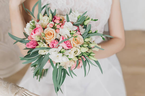 istock Bride with a wedding bouquet in his hands with pink flowers 2233854899