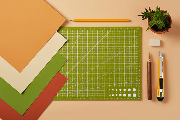 istock Workspace for paper crafts. Colored sheets, cutting mat, pencil, knife, eraser. Space for text. 2233854915