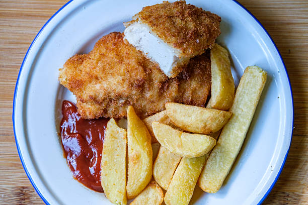 London UK, September 05 2025, Breaded Chicken Fillets With Chuncy Chips And Tomato Sauce