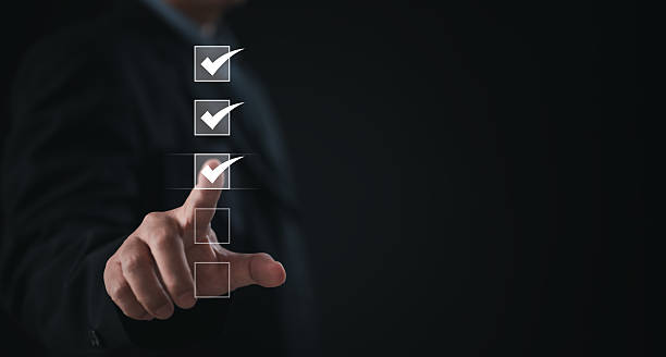 istock Performance checklist concept : businessman using finger with mobile phone for questionnaire, evaluation, assessment online or survey exam and filling out for digital survey and checklist 2233857879