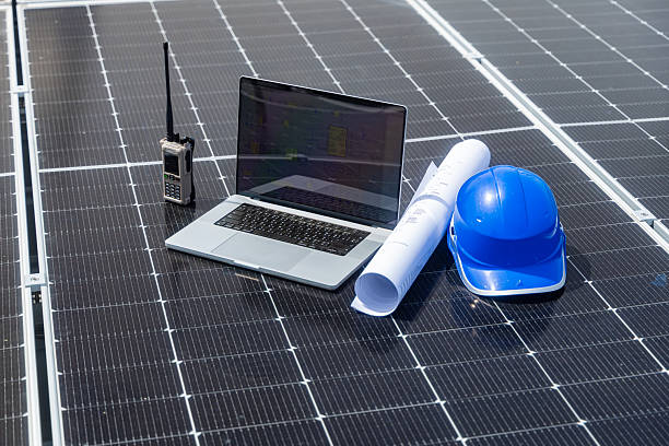 istock Laptop and safety gear on solar panels 2233859123