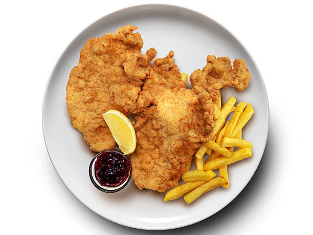 Top view of Plate with Schnitzel with French fries on white background