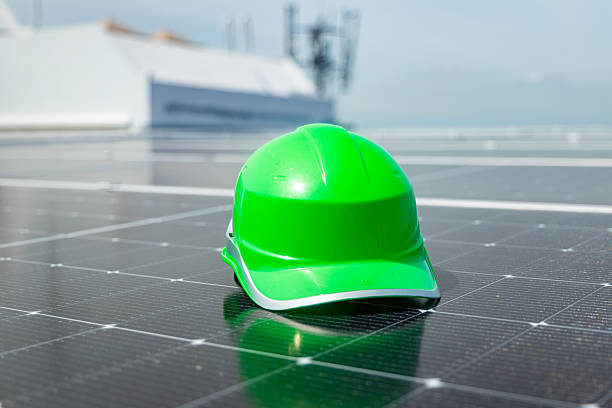 istock Laptop and safety gear on solar panels 2233859595