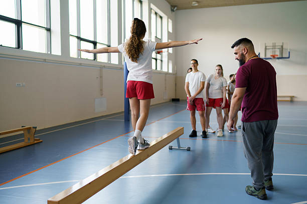 istock Teenage girl balancing on beam during physical education class 2233859964