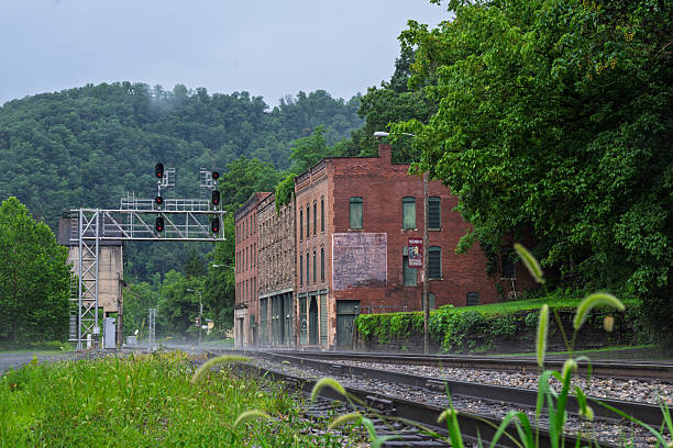 Thurmond, West Virginia in the rain with rail crossing and historic building and bridge.