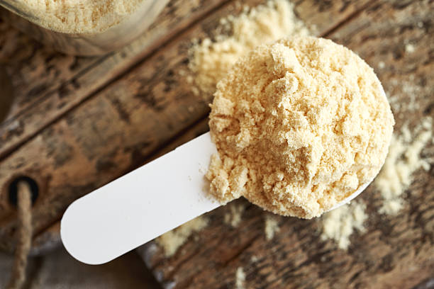 istock Whey protein powder in a measuring spoon on a table, top view 2233861999