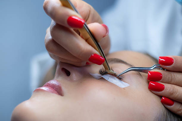 istock Beautician applying eyelash extensions to young woman 2233862366