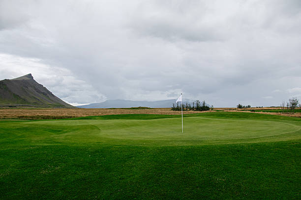 istock Scenic golf course with a mountain backdrop in Iceland under a cloudy sky 2233862475