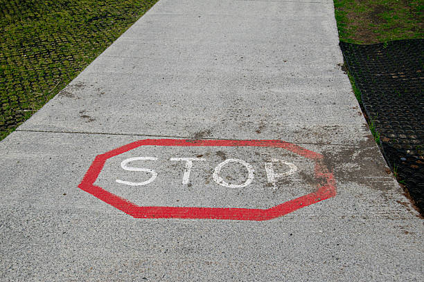 istock Stop sign painted on a sidewalk in Iceland with vibrant red border 2233863203