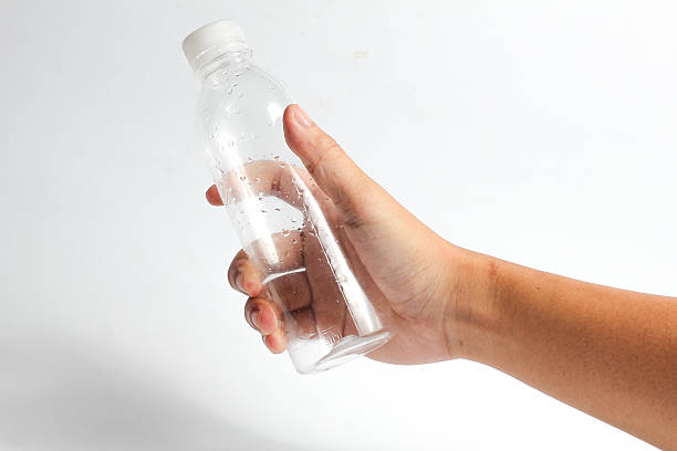 istock Hand holding clear plastic water bottle, showcasing hydration, health, and eco-consciousness 2233863921