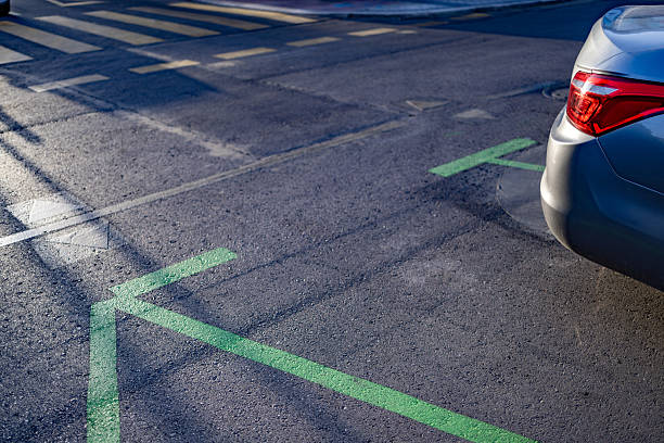 istock Car leaving designated parking spot marked with green lines 2233869105