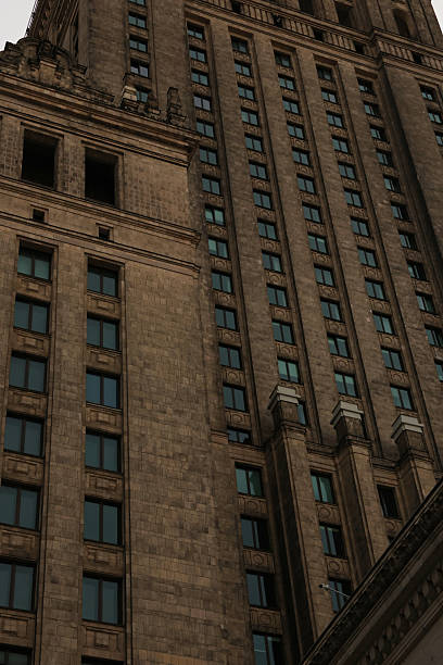 istock Moody architectural detail: imposing brown brick skyscraper facade, geometric window pattern, urban cityscape, low-angle view, somber tone, vintage aesthetic, imposing structure, architectural photography. 2233870923