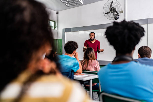 istock Teacher giving lesson to students in modern classroom 2233871865