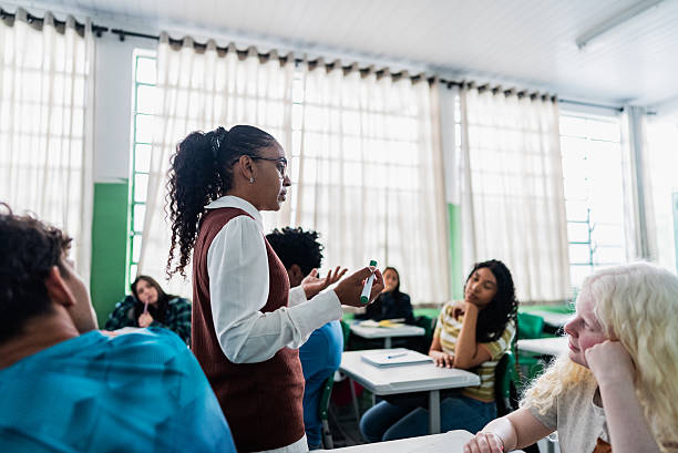 istock Teacher lecturing to diverse group of students in modern classroom 2233872256