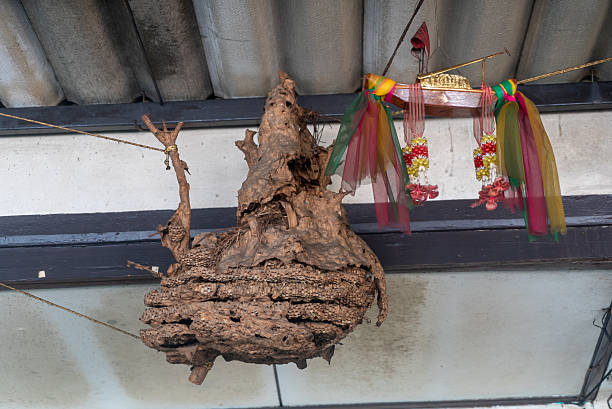 A unique traditional wooden sculpture showcasing intricate craftsmanship. The piece features rustic textures and vibrant decorative elements, ideal for enhancing interior spaces.