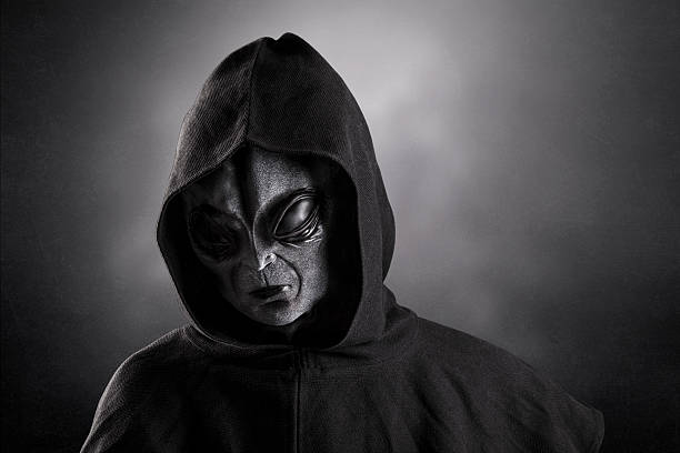 istock Mysterious humanoid alien at night over dark misty background 2233872861