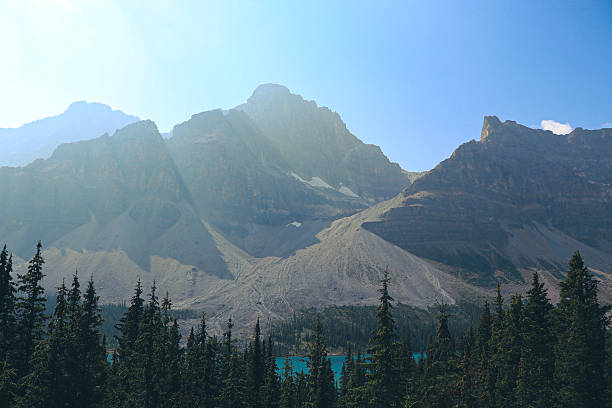 istock Turquoise alpine lake with forest and mountain backdrop 2233873961