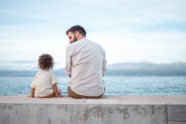 istock Caring Caucasian Father and Diverse Son Enjoying Seaside Relaxation 2233875121