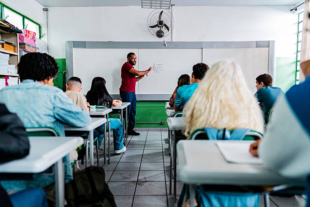 istock Teacher writing on whiteboard during class for students in classroom 2233875908
