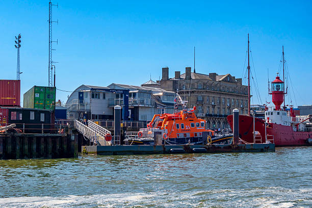 The Royal National Lifeboat Institution (RNLI) building with a lifeboat in Harwich, Essex, Eastern England, seen from the harbour foot ferry.