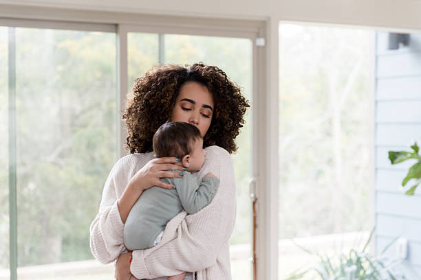 istock Tender Mother Holding Baby Close, Soft Light 2233885117