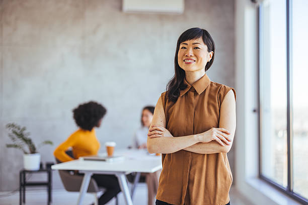 istock Confident Businesswoman Smiling While Collaborating with Team in Modern Office Space 2233887142