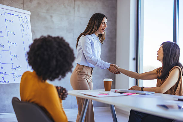 istock Professional Women Greeting During a Business Meeting in a Modern Office Setting 2233887232