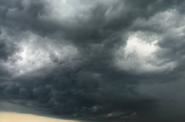 Dark stormy sky with contrasting gray and white clouds creating dramatic atmospheric background for weather, climate, and powerful nature concepts