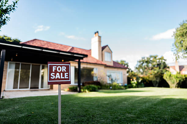 istock House for sale sign at yard 2233889765