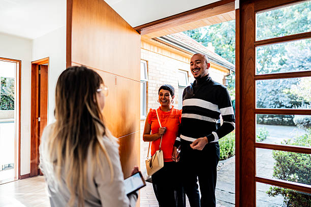 istock Real estate agent greeting customer at real estate 2233889783
