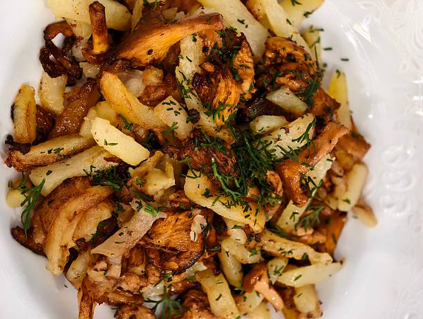 Fried potatoes with wild mushrooms (chanterelles), onions, and fresh dill