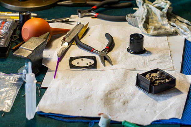 istock Watchmaker’s workshop table with tools, pliers, magnifying glass and watch spare parts carefully arranged, showcasing precision craftsmanship and traditional handwork in horology repair. 2233896932