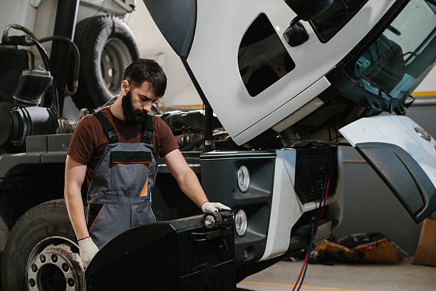 istock Mechanic repairing truck engine in garage workshop 2233898035