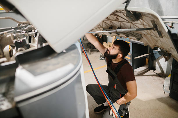 istock Auto mechanic repairing truck engine in garage 2233898099
