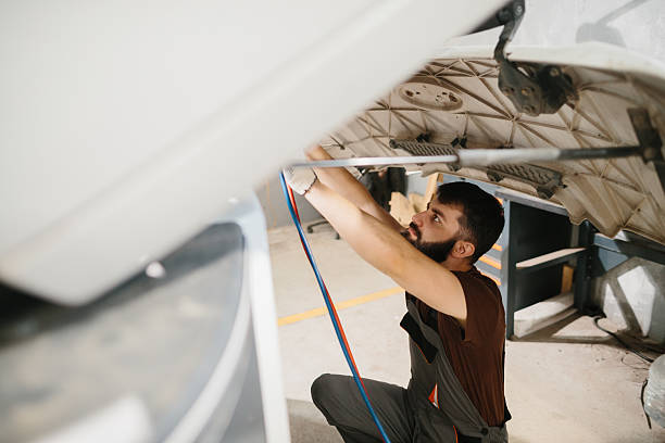 istock Auto mechanic repairing truck engine in garage 2233898111