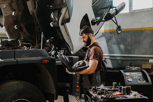 istock Skilled auto mechanic repairing large truck engine 2233898114