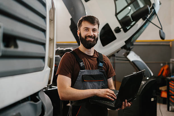 istock Skilled auto mechanic using laptop for truck repair 2233898272