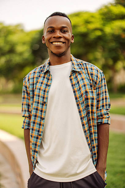istock Smiling young man enjoying outdoors in casual summer outfit 2233899496