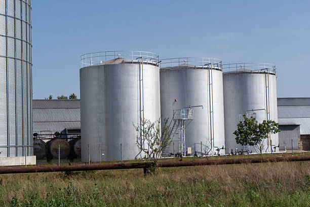istock Grain storage silos and large warehouse hangars at an agricultural facility 2233900140