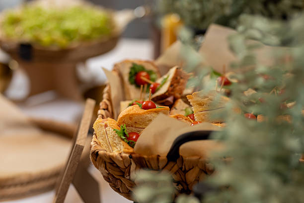 Close-up of triangle sandwiches prepared for a catering event, showcasing fresh ingredients and careful presentation