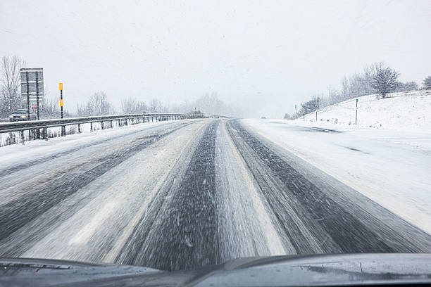 istock Dangerous Hilltop Curve on Winter Blizzard Snow Storm Expressway 2233902209