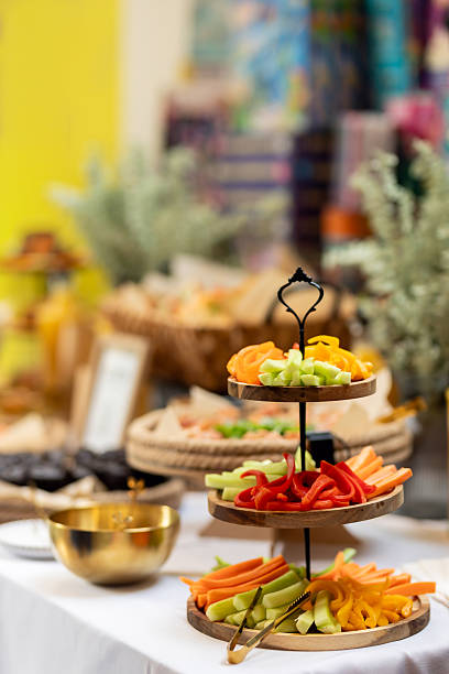 istock Colorful vegetable sticks neatly arranged on multilevel wooden serving board, displaying crisp textures and vivid hues for elegant catered dining presentation 2233902268