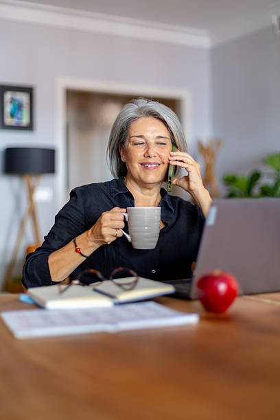 istock Mature woman working remotely while enjoying coffee 2233918337