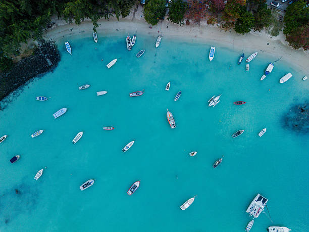 Turquoise waters, anchored boats, and the scenic coastline from above