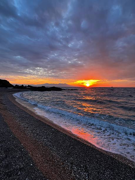 istock Sunset on a cloudy, wavy sea 2233919587