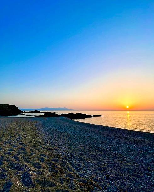 istock Sunset on a calm sea beneath a clear sky 2233919590