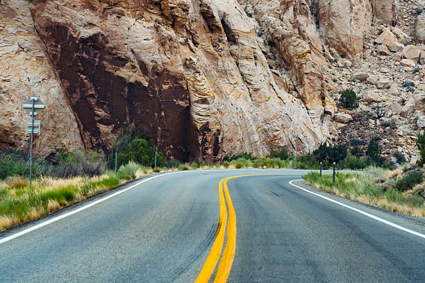 istock Winding Desert Highway Through Rugged Canyon Landscape 2233923980