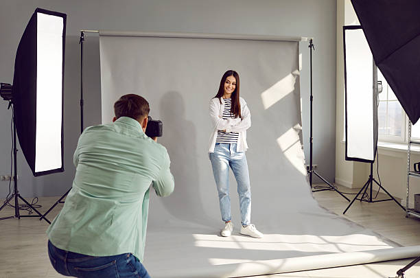 istock Male photographer shooting model in studio with softboxes 2233927370