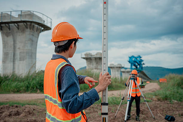istock Engineers are conducting land surveying construction site using theodolite instrument mounted tripod measure land levels and distances project planning in the civil engineering and industrial development sector. 2233929580