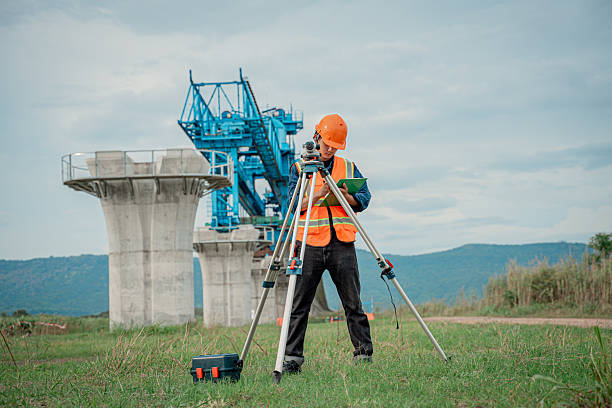 istock Engineers are conducting land surveying construction site using theodolite instrument mounted tripod measure land levels and distances project planning in the civil engineering and industrial development sector. 2233929603